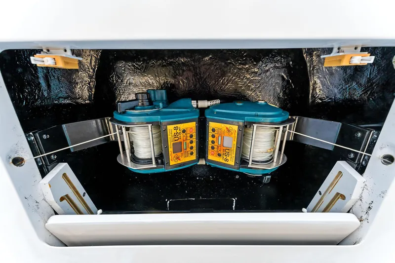 Slide: The Image of Fishing equipment on a 2007 Viking 52 Open boat, featuring dual reels in a storage compartment. - 37