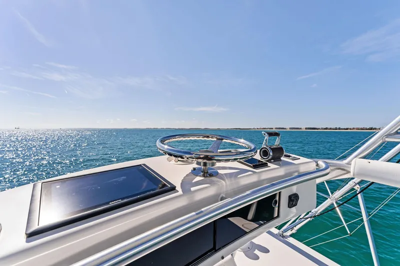 Slide: The Image of 2007 Viking 52 Open yacht helm with ocean view under clear blue sky. - 38