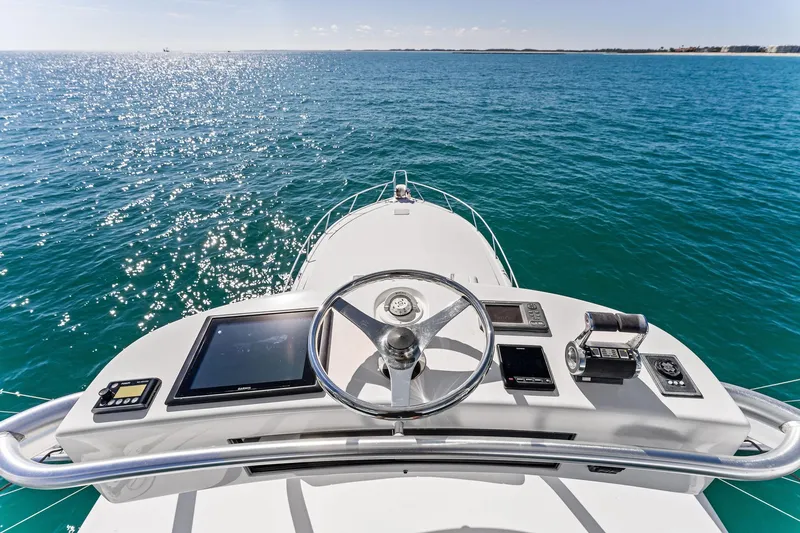 Slide: The Image of 2007 Viking 52 Open yacht helm with ocean view, featuring modern navigation equipment. - 39