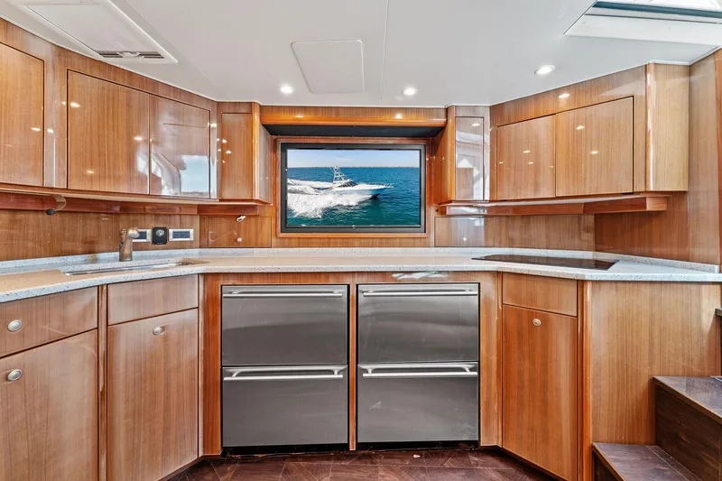 Slide: The Image of Luxurious kitchen interior of 2007 Viking 52 Open yacht with wooden cabinetry and ocean view. - 42