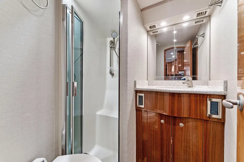Slide: The Image of 2007 Viking 52 Open yacht bathroom with shower and wooden cabinetry. - 47
