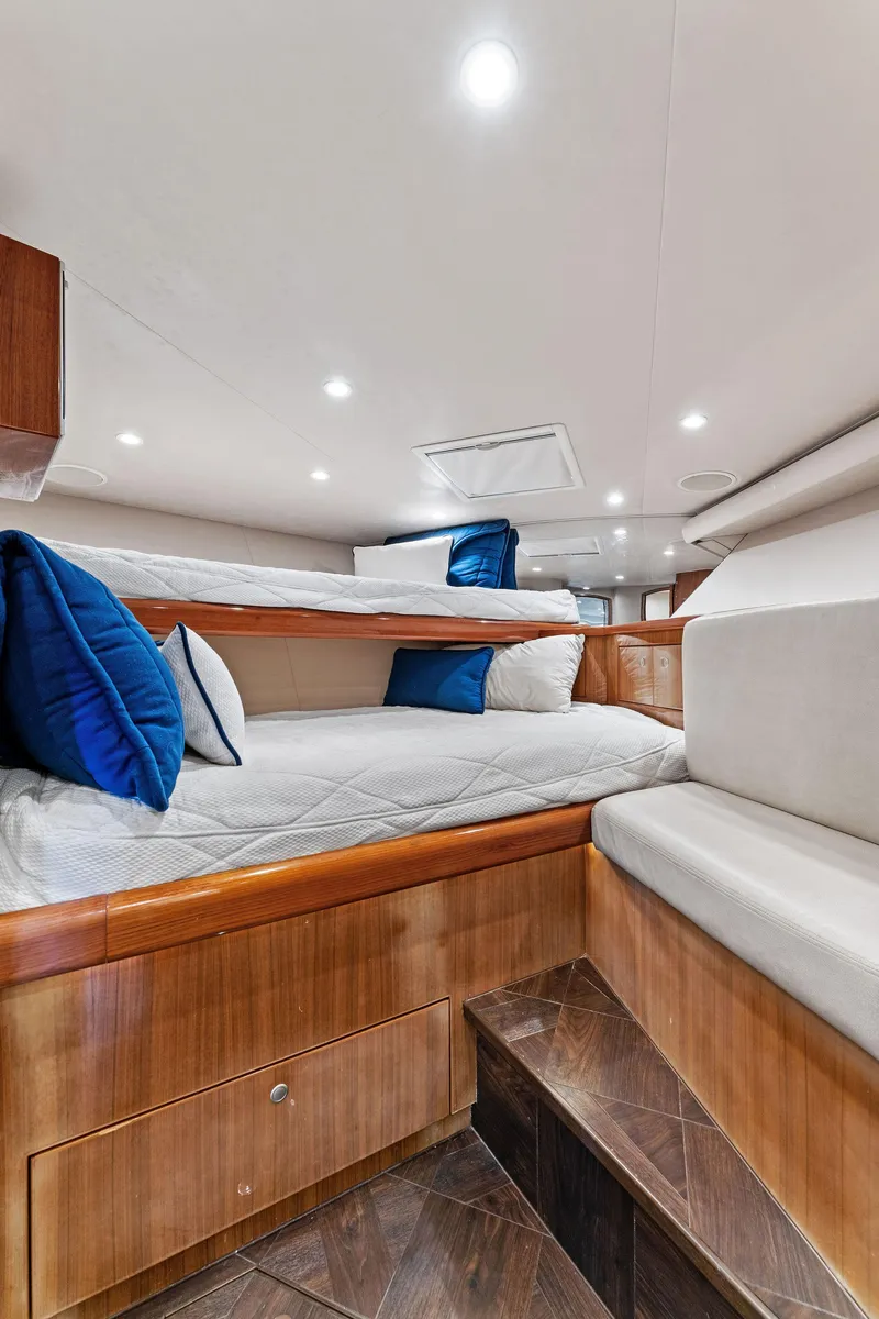 Slide: The Image of 2007 Viking 52 Open yacht interior with cozy bunk beds and elegant wood finish. - 48