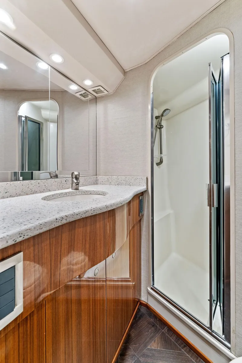 Slide: The Image of 2007 Viking 52 Open yacht bathroom with modern sink and enclosed shower. - 49