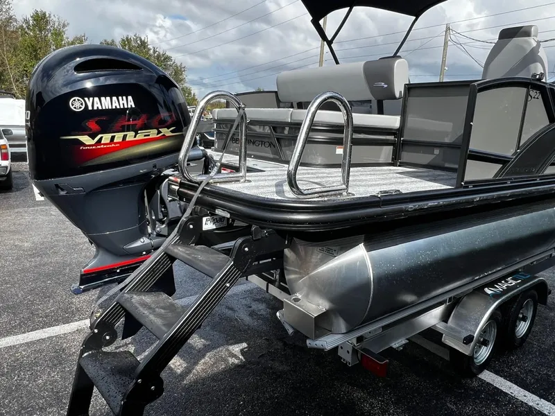 Slide: The Image of 2025 Bennington S 22 pontoon boat with Yamaha VMAX engine, parked on a trailer. - 10
