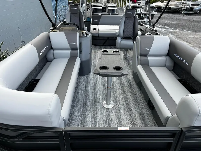 Slide: The Image of 2025 Bennington S 22 pontoon boat interior with gray seating and table. - 11