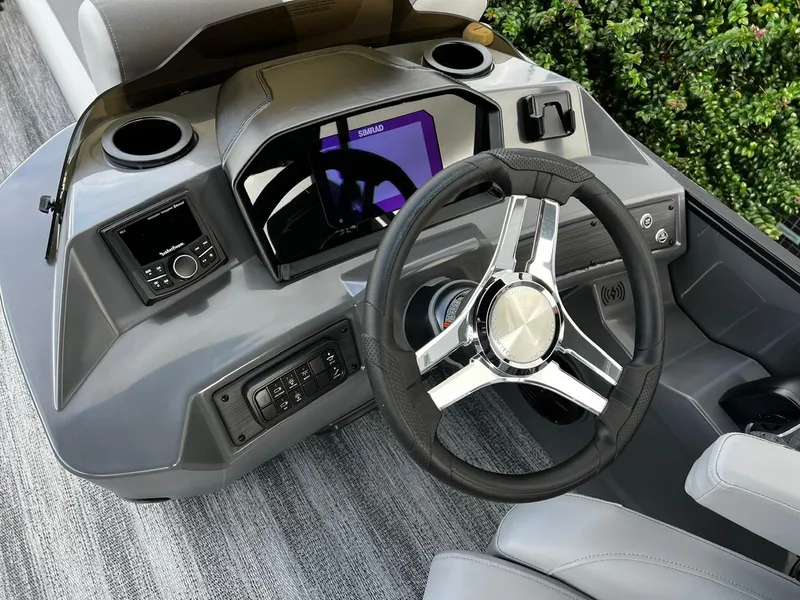 Slide: The Image of 2025 Bennington S 22 boat dashboard with modern steering wheel and controls. - 13