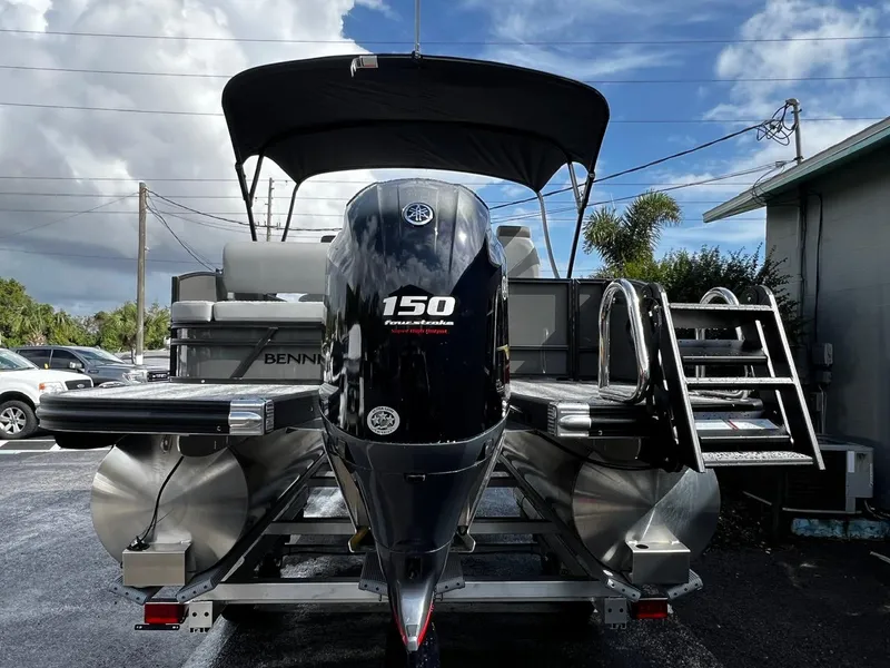 Slide: The Image of 2025 Bennington S 22 pontoon boat with Yamaha 150 engine, parked outdoors. - 8