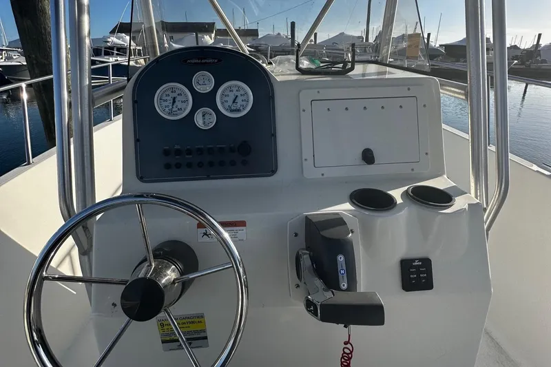 Slide: The Image of 2005 Hydra-Sports 2300 CC boat console with steering wheel and gauges at marina. - 5
