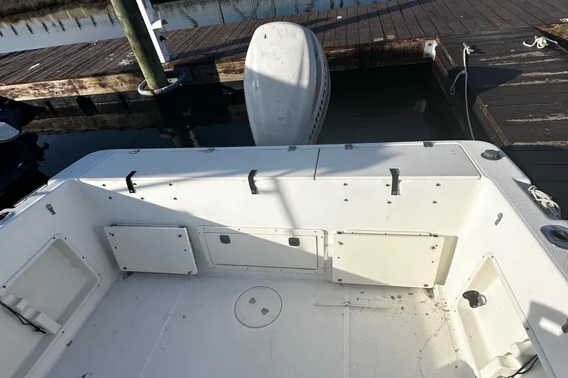 Slide: The Image of 2005 Hydra-Sports 2300 CC boat interior with outboard motor at dock. - 7
