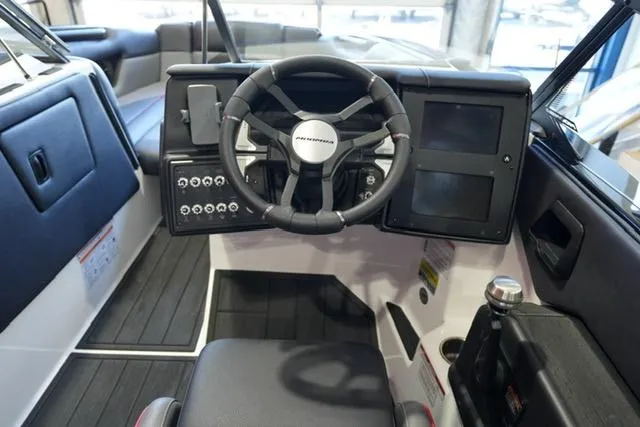 Slide: The Image of 2025 Moomba Mojo boat dashboard with steering wheel and control panel. - 11