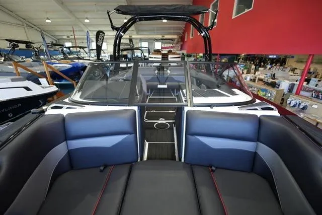 Slide: The Image of 2025 Moomba Mojo boat interior with sleek seating and modern design in showroom. - 9