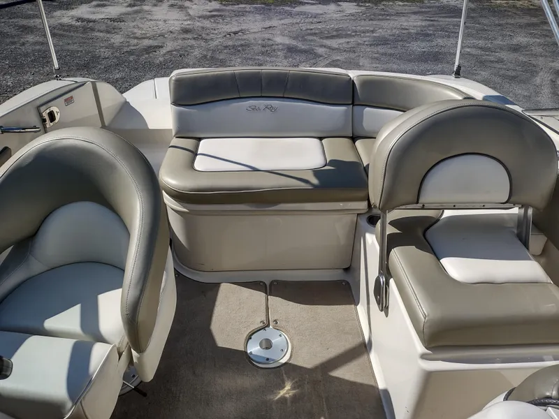 Slide: The Image of 2006 Sea Ray 200 Sundeck interior with cushioned seating and carpeted flooring. - 10
