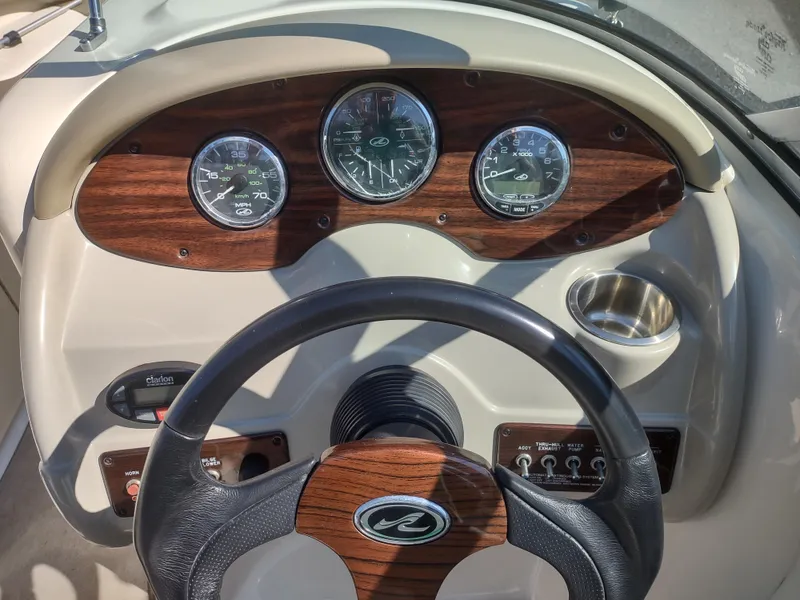 Slide: The Image of 2006 Sea Ray 200 Sundeck dashboard with gauges and steering wheel. - 11