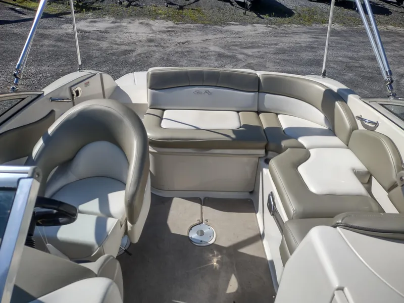 Slide: The Image of 2006 Sea Ray 200 Sundeck interior with beige seating and steering wheel. - 9