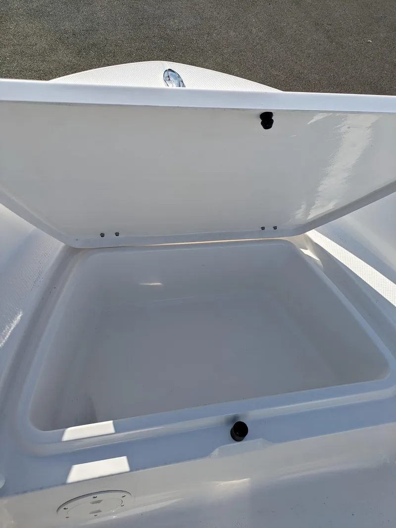 Slide: The Image of 2025 Robalo R160 boat storage compartment open, showcasing spacious interior design. - 11