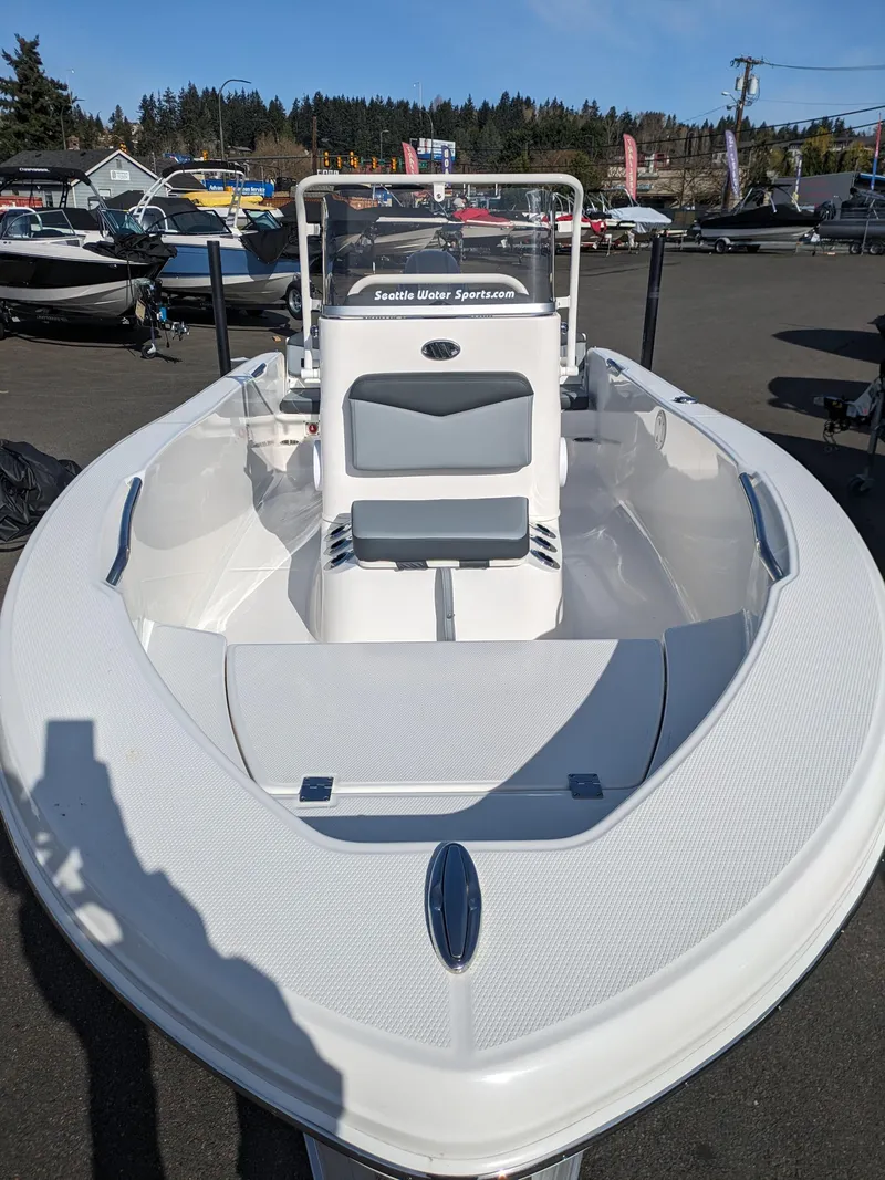 Slide: The Image of 2025 Robalo R160 boat displayed outdoors, showcasing sleek design and spacious seating. - 7