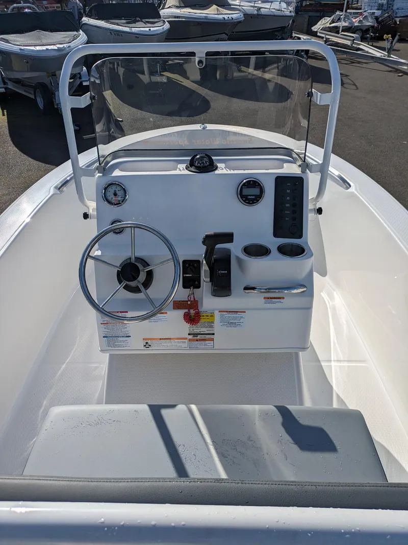 Slide: The Image of 2025 Robalo R160 boat console with steering wheel and gauges. - 8