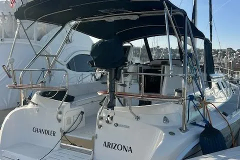 Slide: The Image of 2006 Hunter 44 Deck Salon yacht docked, featuring dual names "Chandler" and "Arizona." - 14