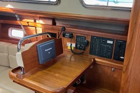 Slide: The Image of 2006 Hunter 44 Deck Salon interior with navigation station and control panels. - 23