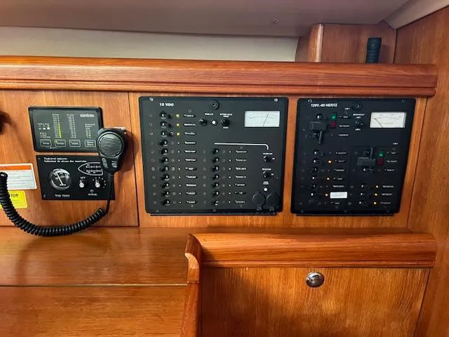 Slide: The Image of Control panel of a 2006 Hunter 44 Deck Salon sailboat, featuring navigation and communication equipment. - 25