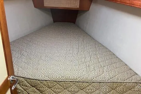 Slide: The Image of 2006 Hunter 44 Deck Salon interior cabin with quilted bed. - 34