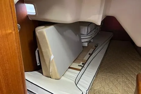 Slide: The Image of Interior cabin of 2006 Hunter 44 Deck Salon with stacked cushions and bedding. - 37