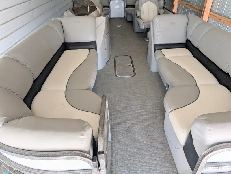 Slide: The Image of 2019 Manitou 25 Encore SE pontoon boat interior with spacious seating and modern design. - 17