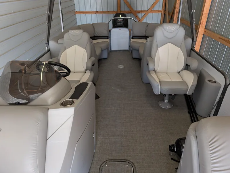 Slide: The Image of 2019 Manitou 25 Encore SE pontoon boat interior with plush seating and modern design. - 18