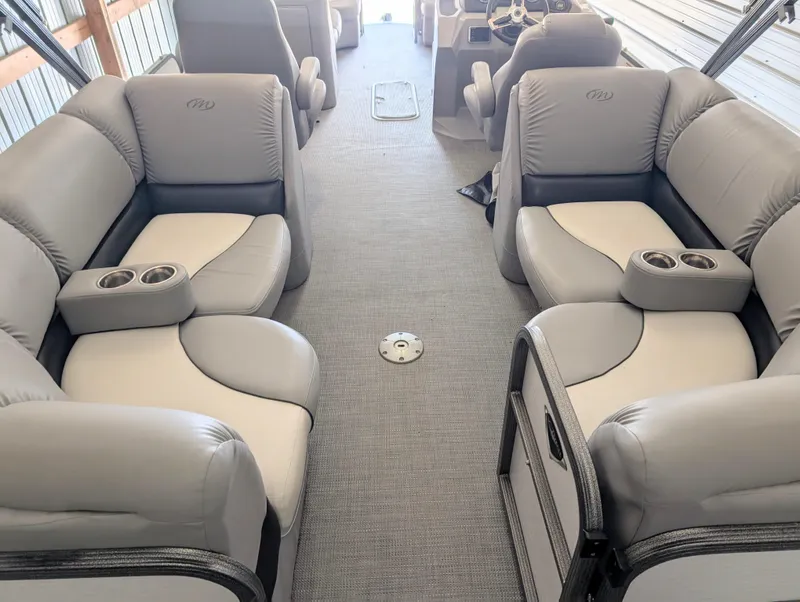 Slide: The Image of 2019 Manitou 25 Encore SE interior with plush seating and cup holders. - 21