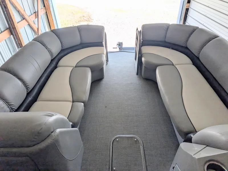 Slide: The Image of 2019 Manitou 25 Encore SE pontoon boat interior with plush seating. - 23