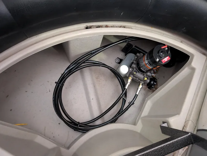 Slide: The Image of 2019 Manitou 25 Encore SE boat storage compartment with cables and equipment. - 29