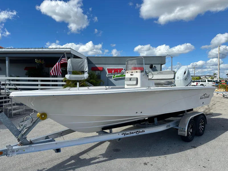 The Image of 2025 Sea Chaser 21 LX boat on trailer, parked outdoors under blue sky. - 0