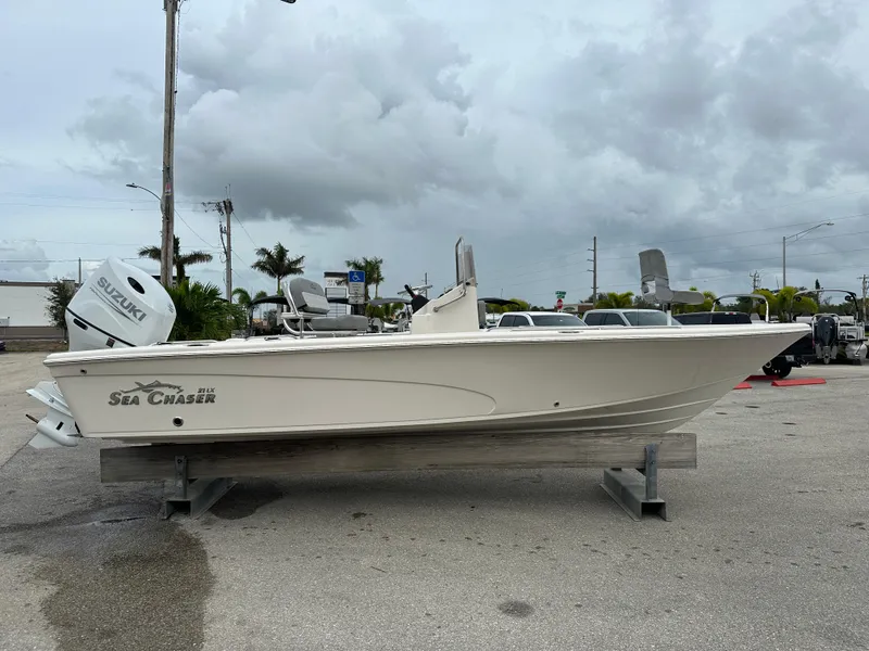 Slide: The Image of 2025 Sea Chaser 21 LX boat on display in a parking lot. - 12