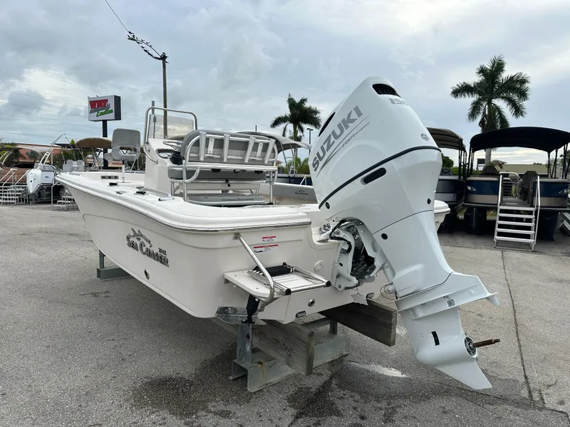 Slide: The Image of 2025 Sea Chaser 21 LX boat with Suzuki outboard motor in a marina setting. - 15