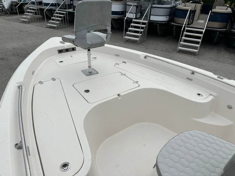 Slide: The Image of 2025 Sea Chaser 21 LX boat deck with seating and storage compartments. - 20