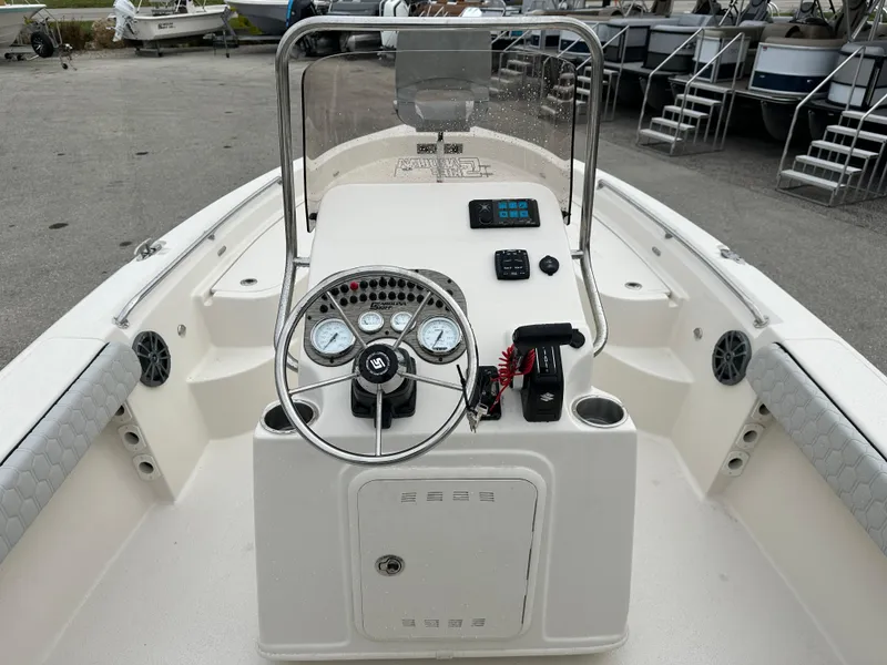 Slide: The Image of 2025 Sea Chaser 21 LX boat console with steering wheel and controls. - 30