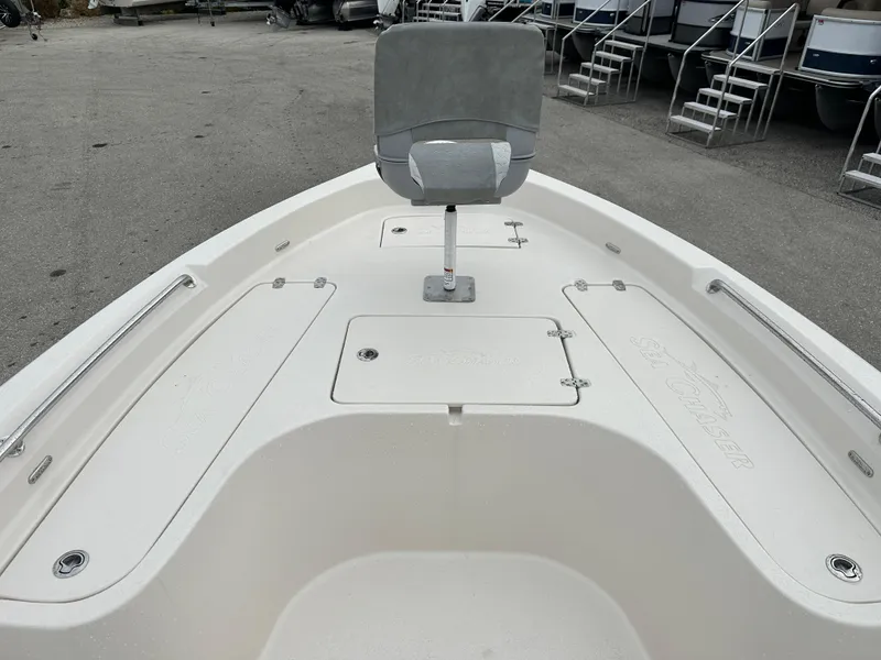 Slide: The Image of 2025 Sea Chaser 21 LX boat deck with seating and storage compartments. - 31