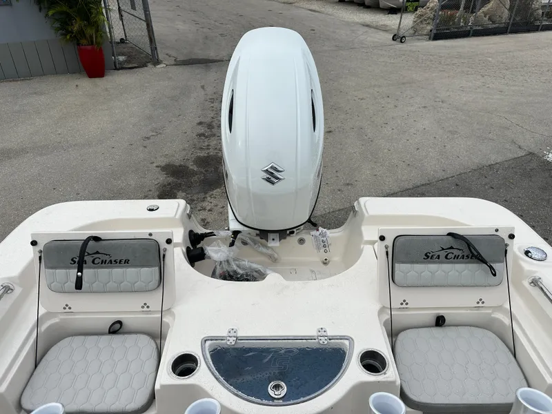 Slide: The Image of 2025 Sea Chaser 21 LX boat with Suzuki outboard motor, rear seating, and storage compartments. - 37