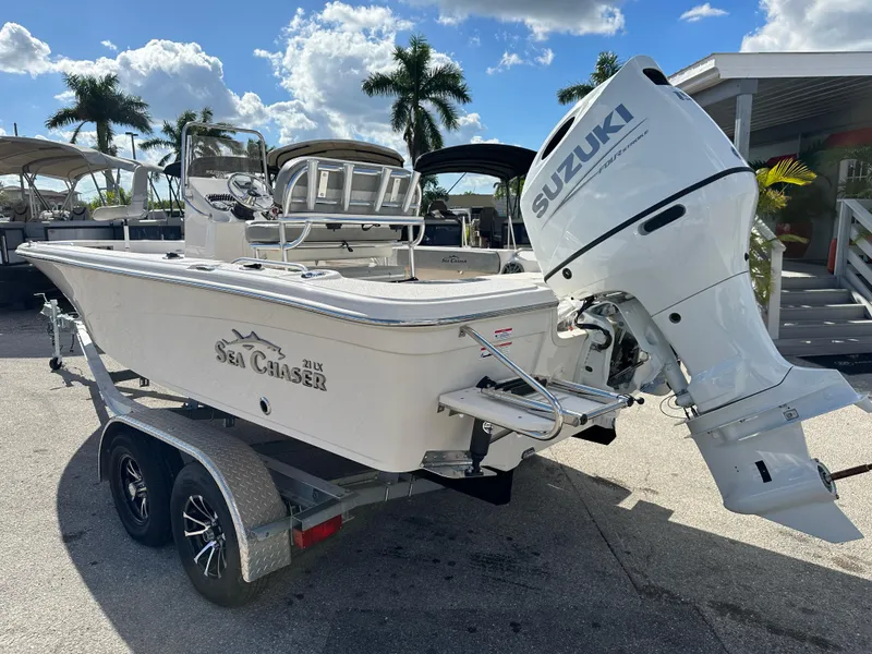 Slide: The Image of 2025 Sea Chaser 21 LX boat with Suzuki outboard motor on trailer. - 8