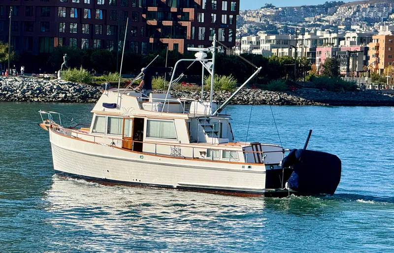 Slide: The Image of 1979 Grand Banks Classic yacht cruising near urban waterfront. - 1