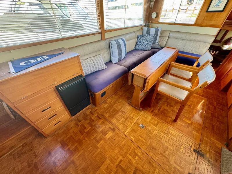 Slide: The Image of 1979 Grand Banks Classic yacht interior with wood flooring and comfortable seating. - 24