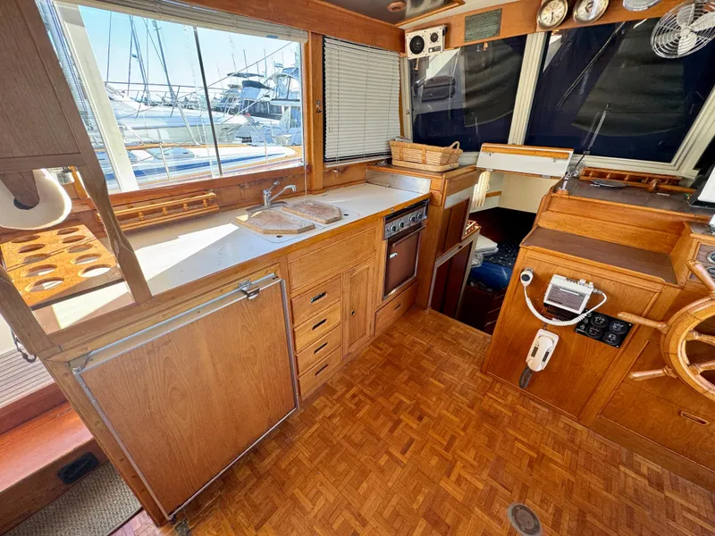 Slide: The Image of 1979 Grand Banks Classic yacht interior with wooden cabinetry and nautical instruments. - 12