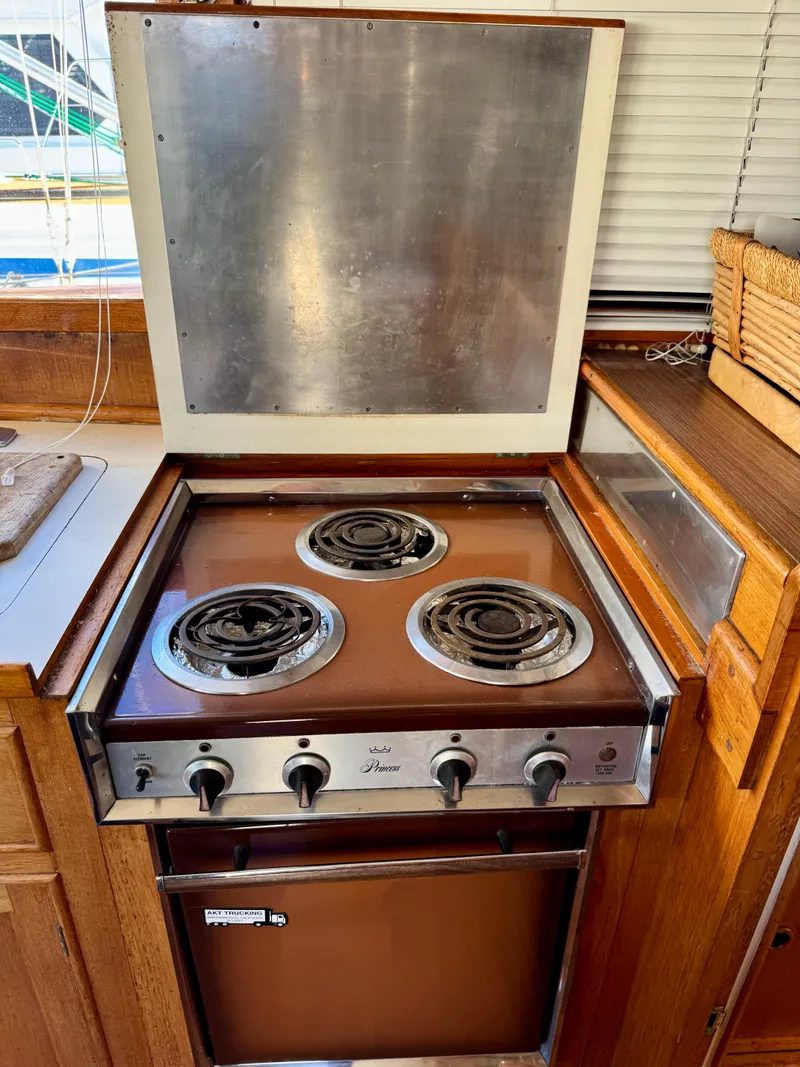 Slide: The Image of Vintage 1979 Grand Banks Classic stove with three burners in a wooden kitchen setting. - 14