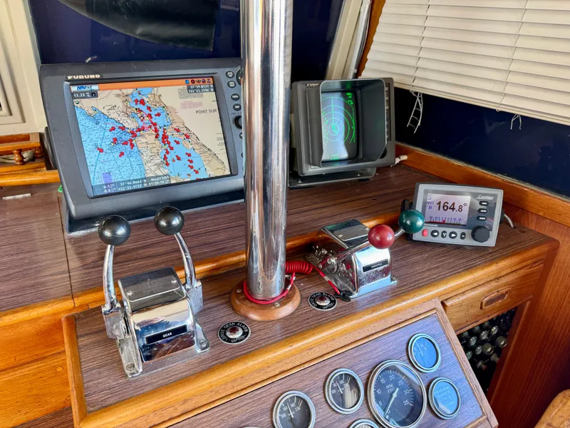 Slide: The Image of 1979 Grand Banks Classic boat dashboard with navigation equipment and controls. - 18