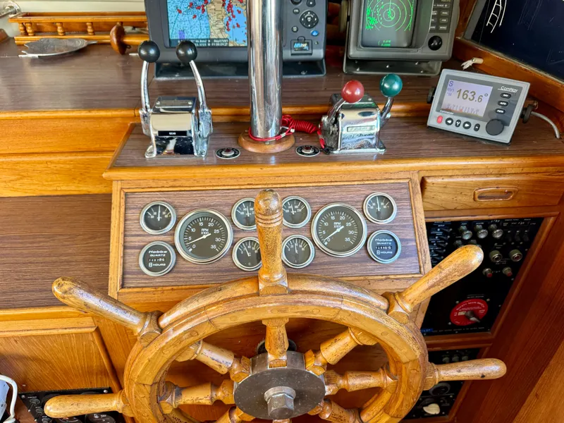 Slide: The Image of 1979 Grand Banks Classic helm with wooden wheel and navigation instruments. - 19