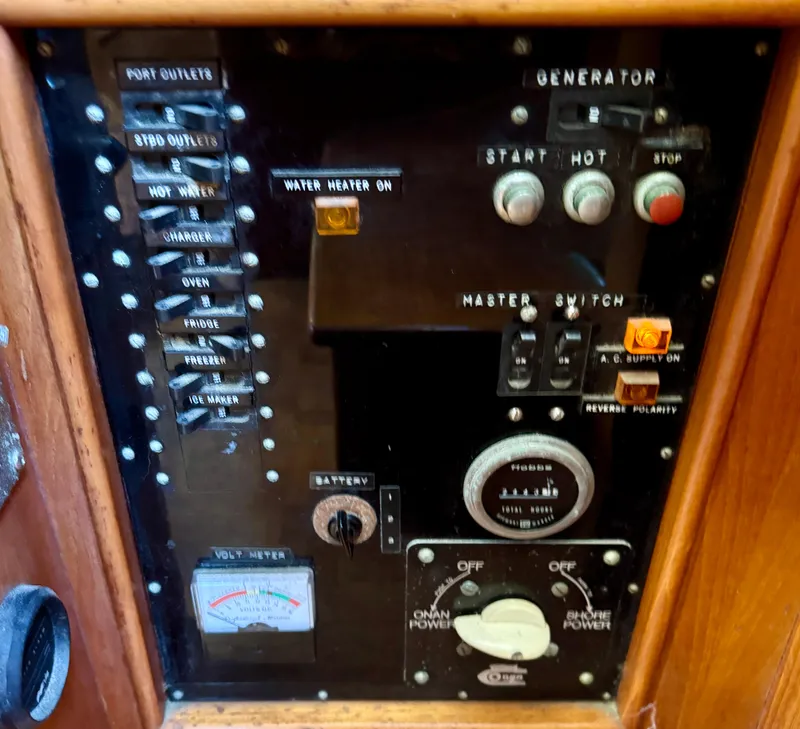 Slide: The Image of 1979 Grand Banks Classic control panel with generator and power switches. - 21