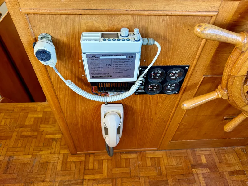 Slide: The Image of 1979 Grand Banks Classic boat dashboard with radio and gauges. - 22