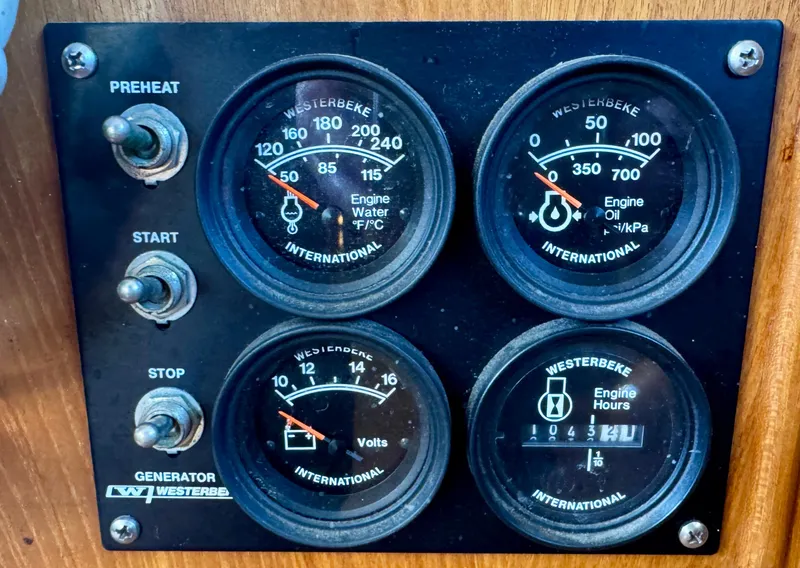 Slide: The Image of 1979 Grand Banks Classic control panel with Westerbeke gauges and switches. - 23