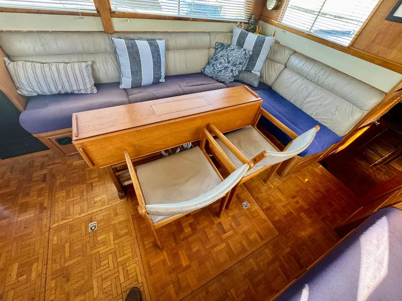 Slide: The Image of 1979 Grand Banks Classic yacht interior with wooden flooring and cozy seating area. - 25