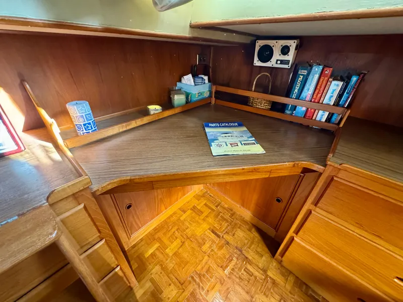 Slide: The Image of 1979 Grand Banks Classic boat interior with wooden desk and bookshelves. - 29